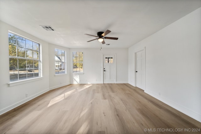 unfurnished room with light hardwood / wood-style flooring, plenty of natural light, and ceiling fan