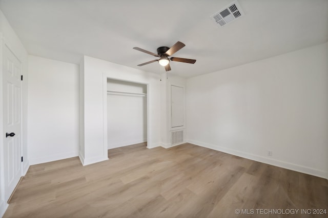 unfurnished bedroom with a closet, light wood-type flooring, and ceiling fan