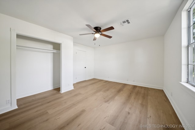 unfurnished bedroom with light hardwood / wood-style flooring, multiple windows, and ceiling fan