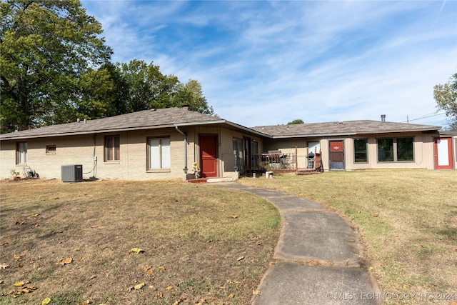 ranch-style house with central AC and a front yard