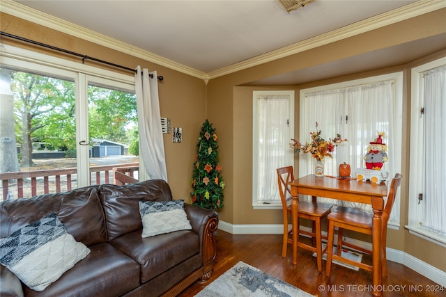 living room featuring a wealth of natural light, ornamental molding, and dark wood-type flooring