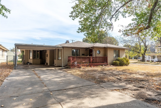 ranch-style house featuring a deck and a carport