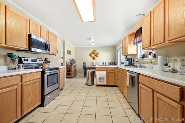 kitchen with sink, light tile patterned flooring, kitchen peninsula, and stainless steel appliances