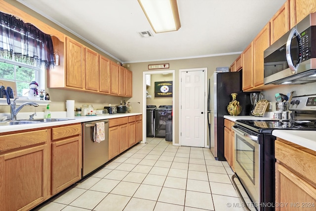 kitchen with sink, light tile patterned floors, appliances with stainless steel finishes, and ornamental molding