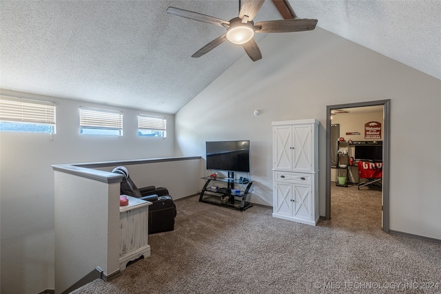 interior space featuring a textured ceiling, carpet, lofted ceiling, and ceiling fan