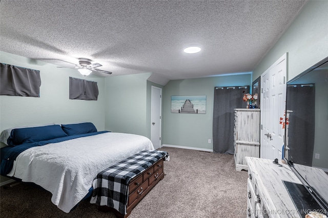 bedroom featuring a closet, a textured ceiling, light colored carpet, and ceiling fan