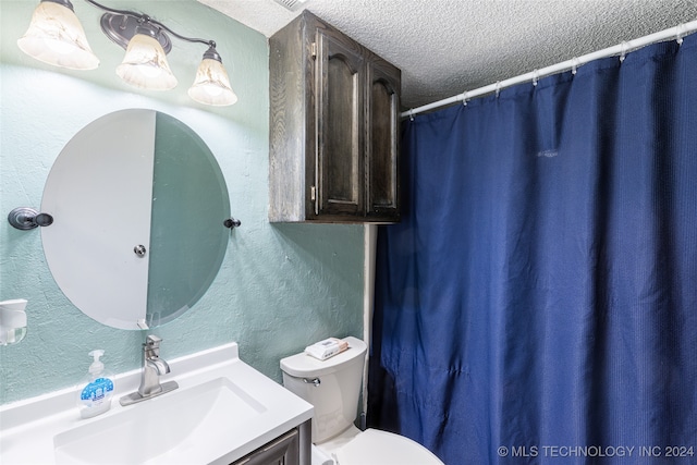 bathroom with vanity, a textured ceiling, toilet, and a shower with shower curtain