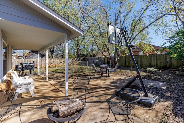 view of patio featuring a fire pit and a grill