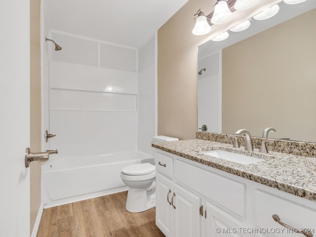 full bathroom featuring vanity, hardwood / wood-style floors, shower / bathing tub combination, and toilet