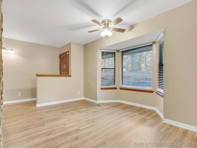 empty room with light wood-type flooring and ceiling fan