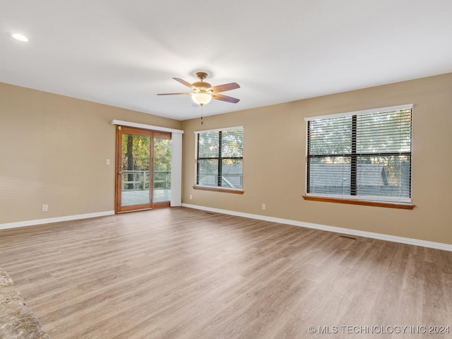 spare room featuring ceiling fan and light hardwood / wood-style flooring