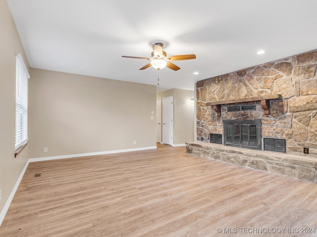 unfurnished living room with a fireplace, light hardwood / wood-style floors, and ceiling fan