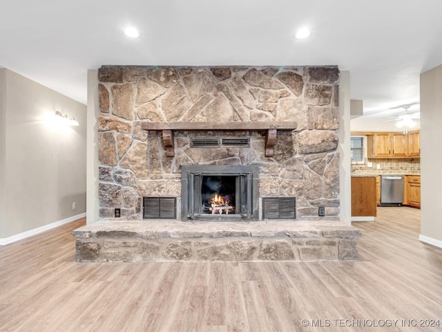 unfurnished living room featuring light hardwood / wood-style flooring, a fireplace, and ceiling fan