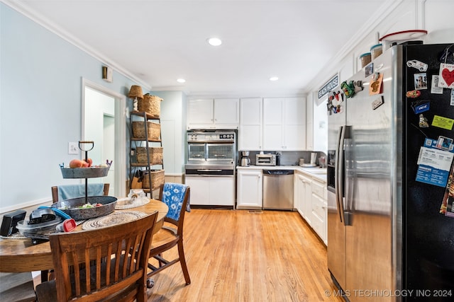 kitchen featuring appliances with stainless steel finishes, light hardwood / wood-style flooring, white cabinetry, and crown molding