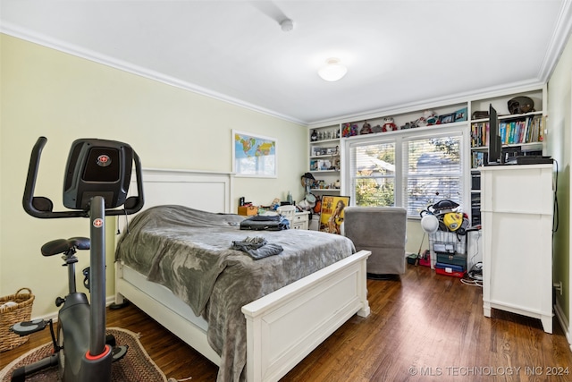 bedroom featuring crown molding and dark hardwood / wood-style floors