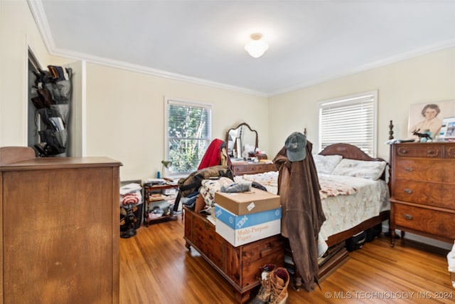 bedroom featuring crown molding and hardwood / wood-style flooring