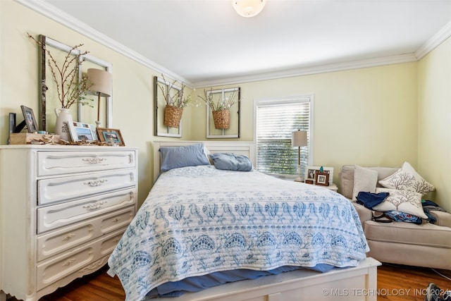 bedroom featuring hardwood / wood-style flooring and ornamental molding