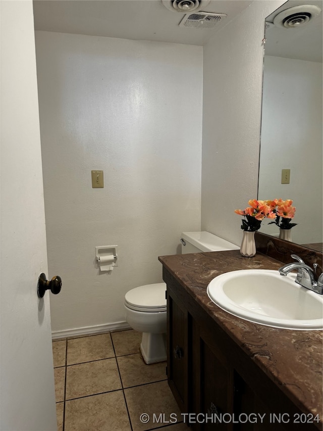 bathroom featuring toilet, vanity, and tile patterned floors