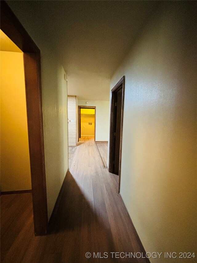 hall with wood-type flooring