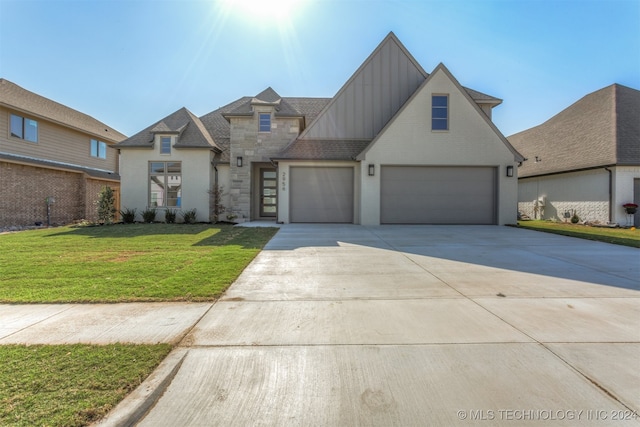 view of front of house featuring a front lawn and a garage