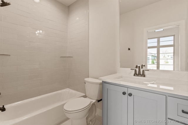 full bathroom with vanity, tiled shower / bath combo, and toilet