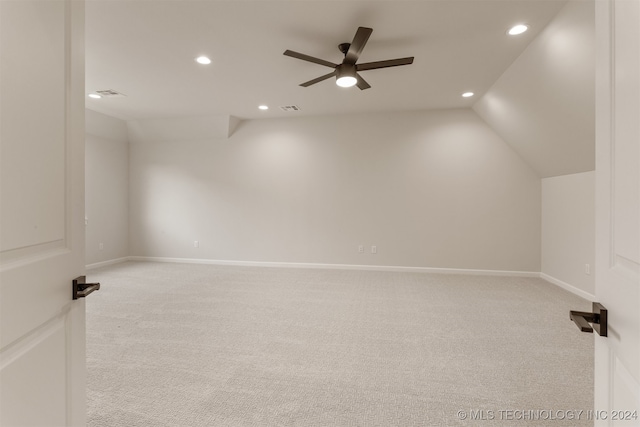 carpeted empty room featuring lofted ceiling and ceiling fan