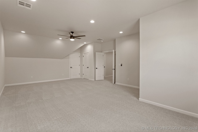 bonus room featuring ceiling fan, lofted ceiling, and light colored carpet