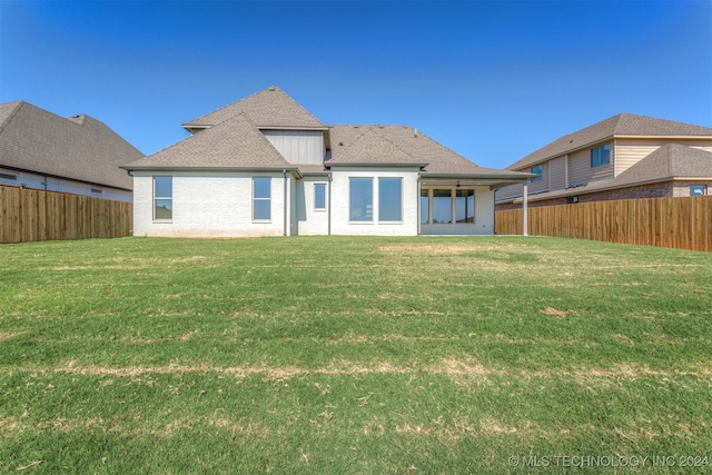 rear view of house with a lawn