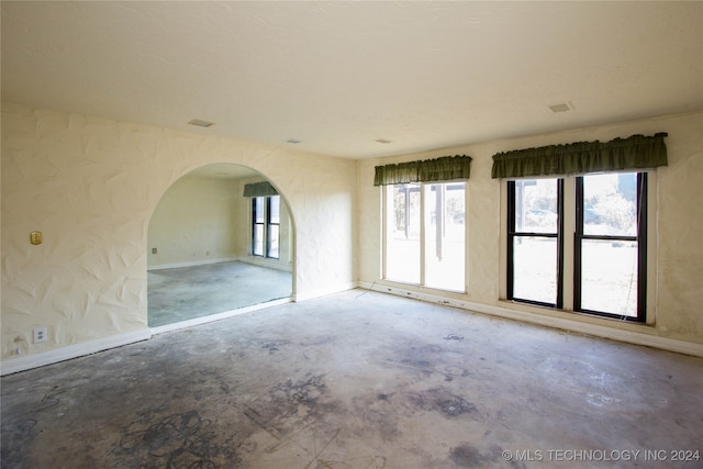 unfurnished room featuring concrete floors