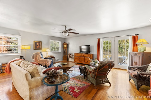 living room featuring light hardwood / wood-style flooring, a healthy amount of sunlight, and ceiling fan