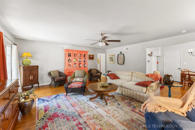 living room featuring hardwood / wood-style floors and ceiling fan