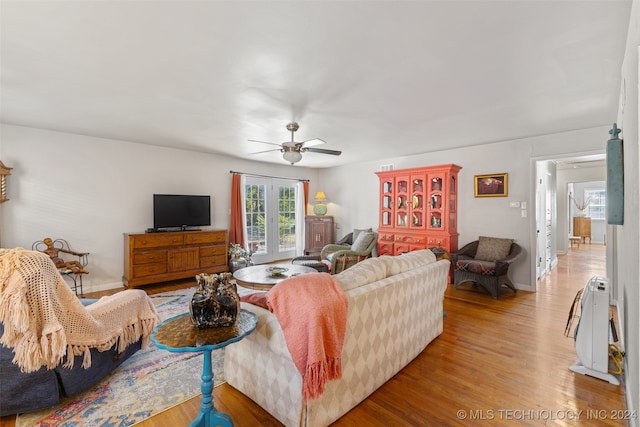 living room featuring hardwood / wood-style floors and ceiling fan