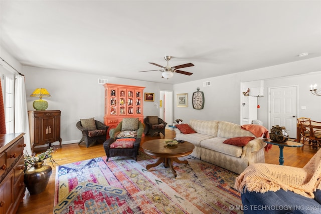 living room featuring wood-type flooring and ceiling fan