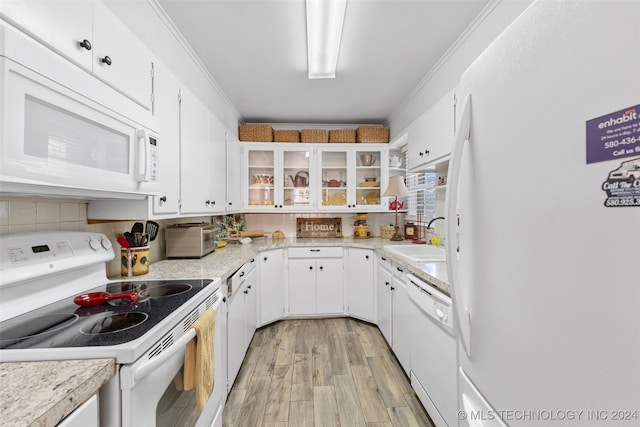 kitchen featuring crown molding, white cabinetry, sink, and white appliances