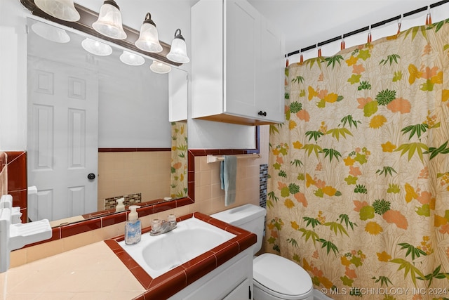 bathroom featuring toilet, vanity, and a shower with shower curtain