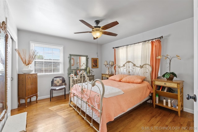 bedroom with light hardwood / wood-style floors and ceiling fan