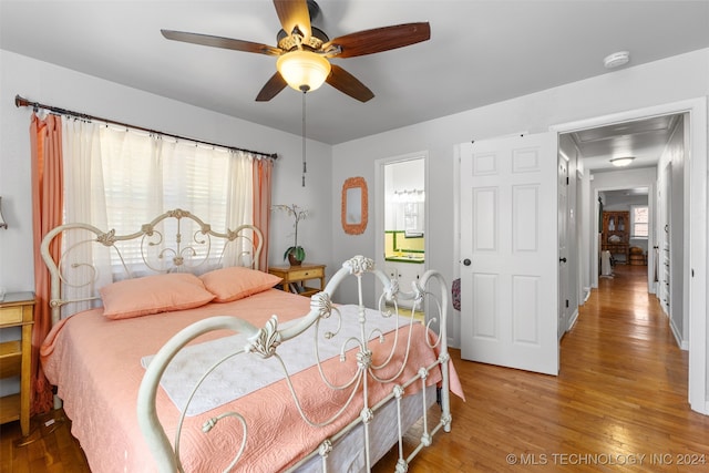 bedroom with wood-type flooring and ceiling fan