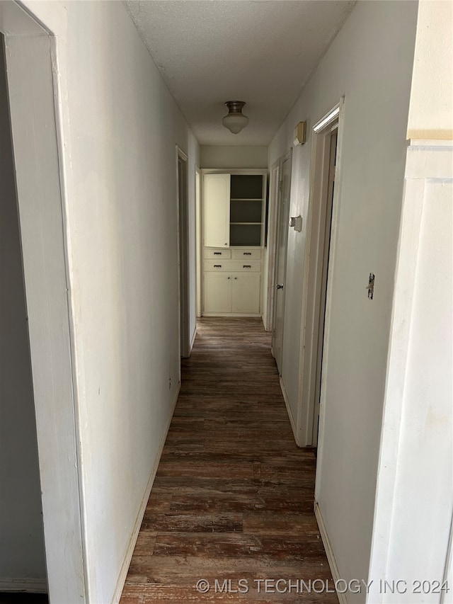 corridor with dark wood-type flooring