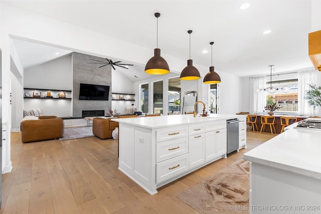 kitchen featuring white cabinetry, a center island with sink, vaulted ceiling, and a wealth of natural light