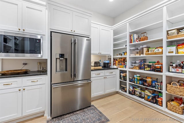 kitchen featuring white cabinetry, appliances with stainless steel finishes, and light hardwood / wood-style flooring