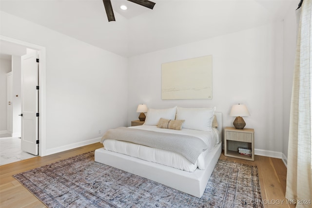 bedroom with hardwood / wood-style floors and ceiling fan