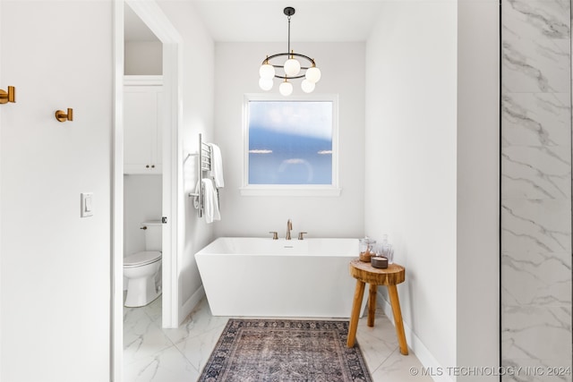 bathroom with toilet, a chandelier, and a bath