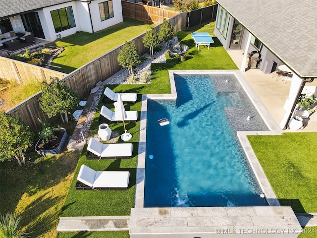 view of pool with a yard and a patio