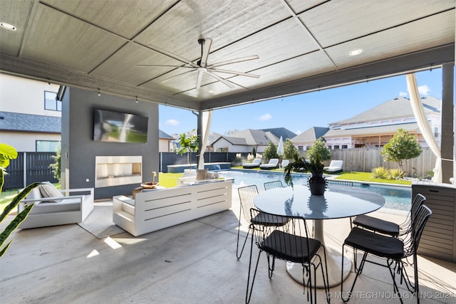 view of patio / terrace with ceiling fan and a fenced in pool