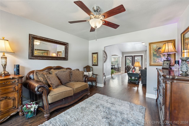 living room with dark hardwood / wood-style floors, vaulted ceiling, and ceiling fan