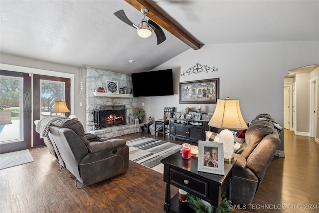 living room featuring ceiling fan, hardwood / wood-style flooring, vaulted ceiling with beams, and a fireplace