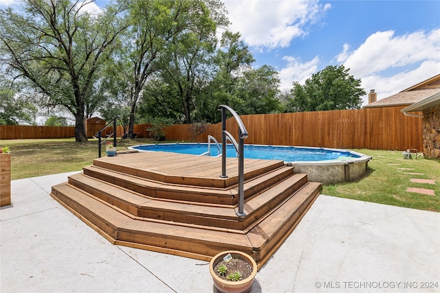 view of pool featuring a patio and a yard