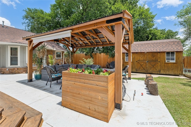 view of patio / terrace with a gazebo, a storage unit, and an outdoor living space