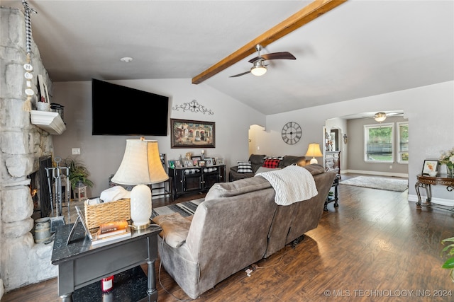 living room featuring ceiling fan, lofted ceiling with beams, a stone fireplace, and dark hardwood / wood-style flooring