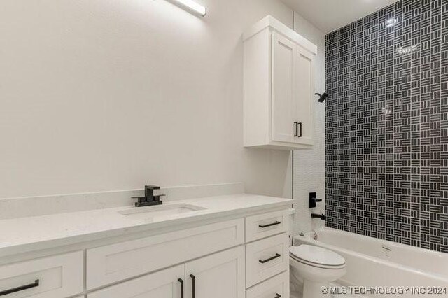 full bathroom with toilet, tiled shower / bath combo, and vanity